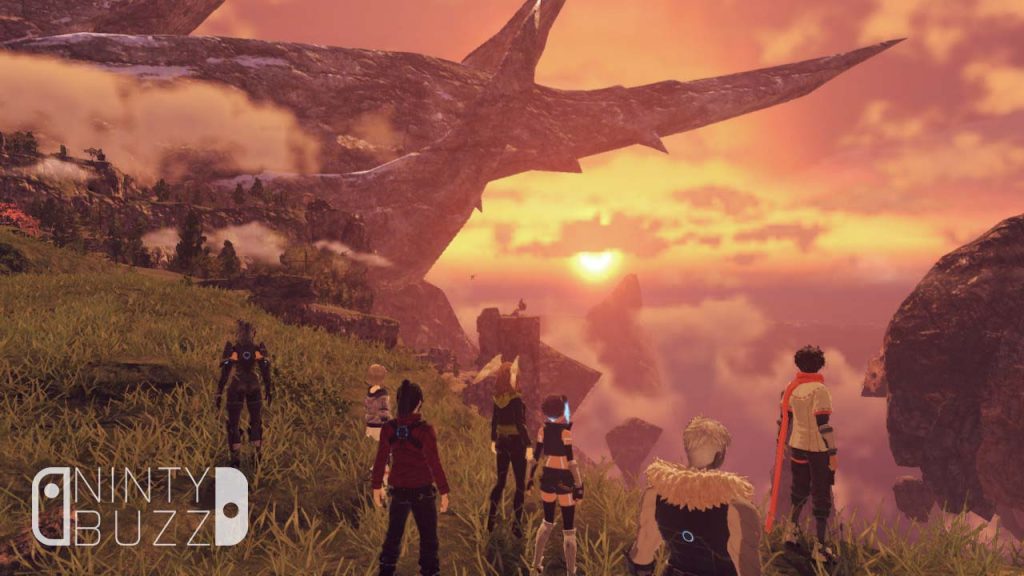 The cast of the game look out on an orange baked lanscape during a sunset from atop a cliff. The shape of a long-dead titan can be seen in the distance.